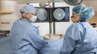 Interventional radiologists in scrubs doing a procedure.